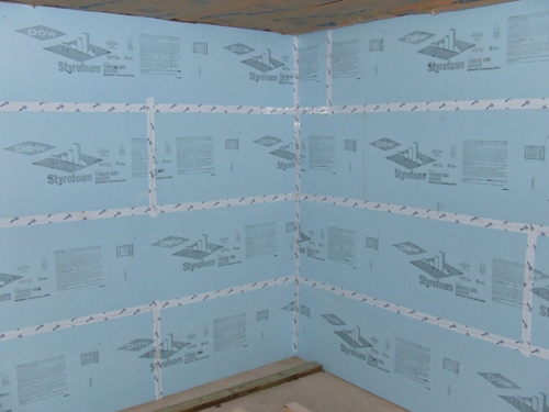 Picture of foam board sealed with Tyvek tape in a basement.