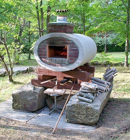 Pizza oven built in elliptical concrete drainage pipe.